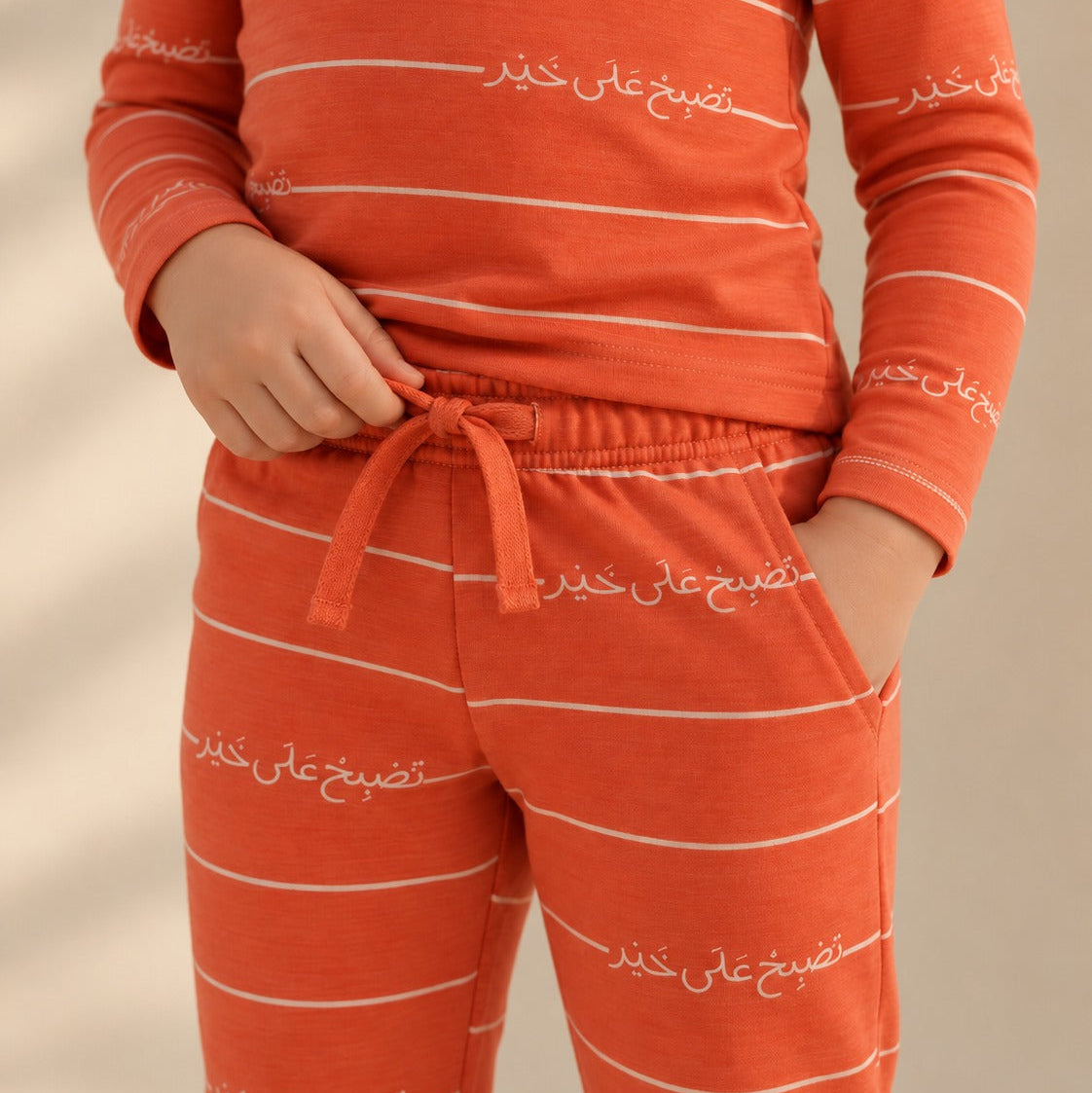 Close-up of the Arabic print, waistband and pocket on Arnoob pajamas