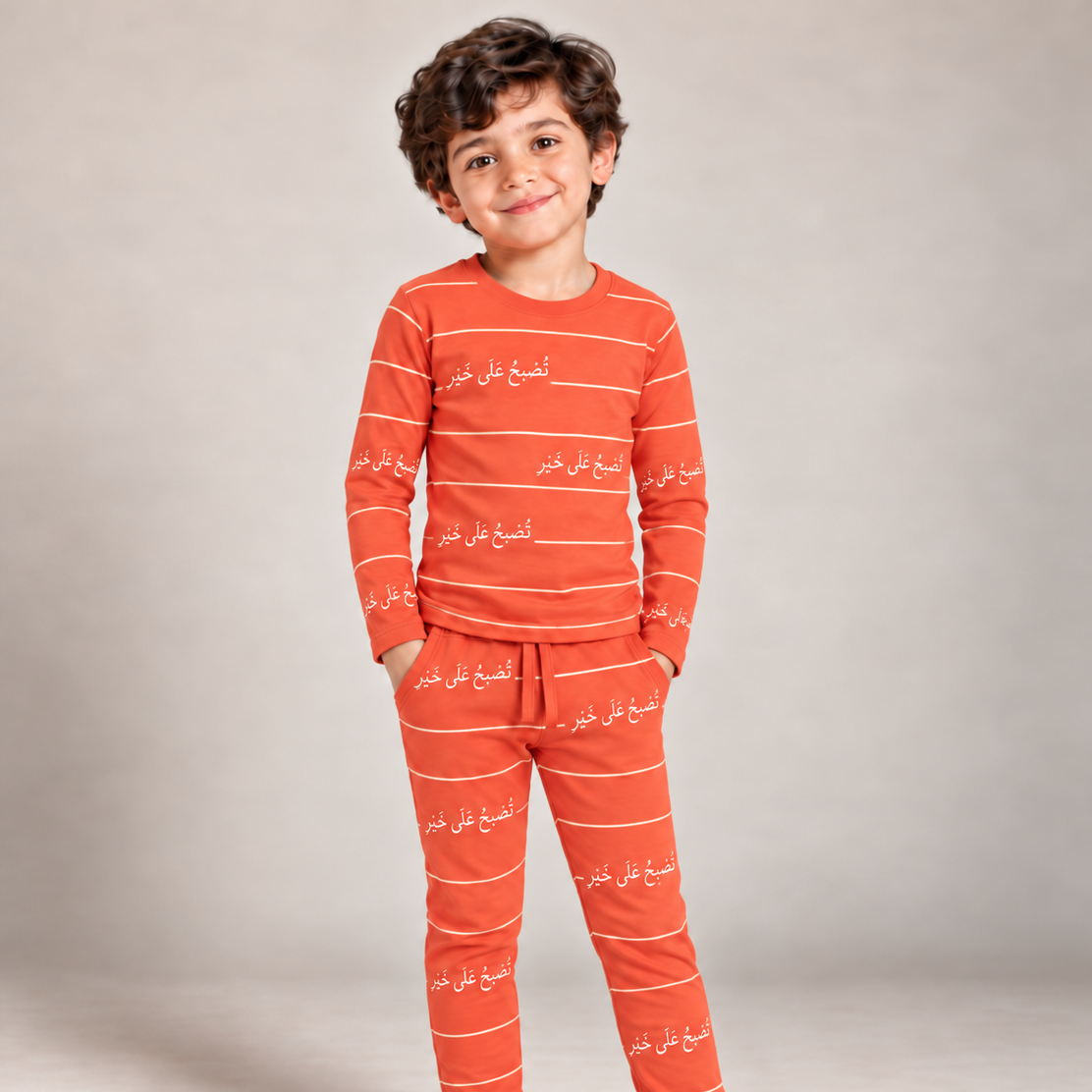 Child wearing orange Arnoob Arabic bedtime pajamas by Dardasha x Nohm
